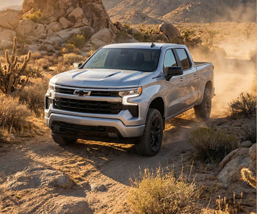 Chevrolet Silverado pickup truck driving off-road through desert terrain