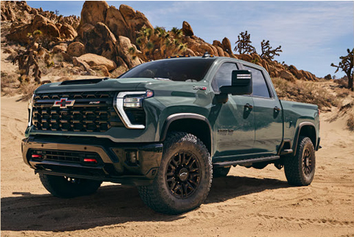 green Chevrolet Silverado ZR2 off road truck on rocky desert terrain