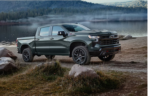 Chevrolet Silverado ZR2 pickup truck parked beside a lakeside campsite
