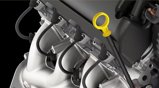 close-up of a vehicle engine showing the engine oil dipstick and intake components