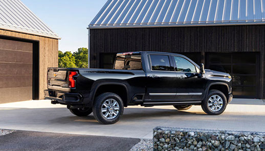 Chevrolet Silverado parked at a modern home, showcasing full-size truck practicality, everyday utility, and premium pickup truck design