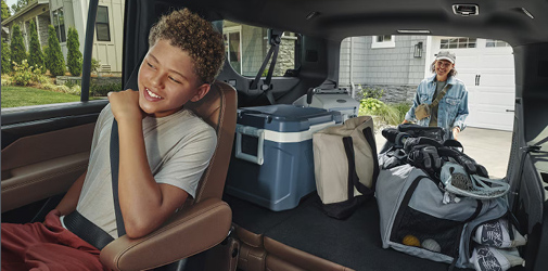 A teenager sitting inside a Chevrolet vehicle